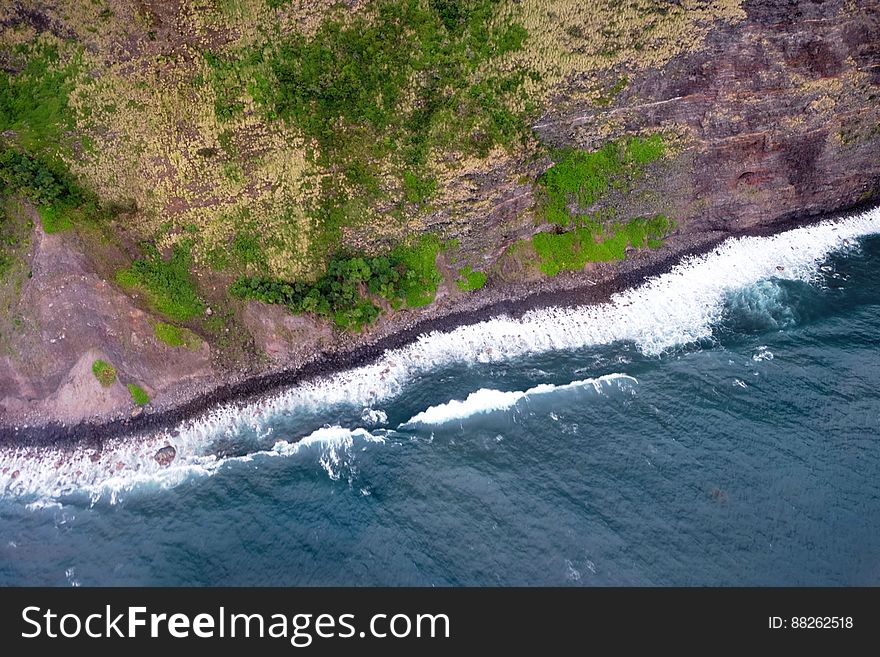 Sky View Of Ocean Against Cliff