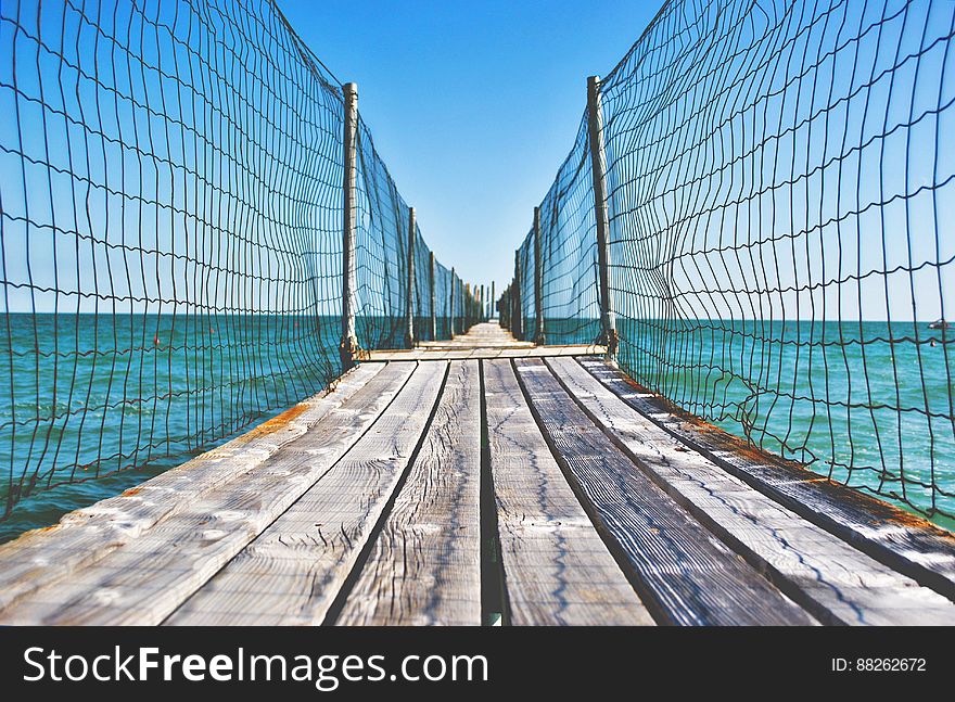 Fenced Wooden Boardwalk Over Ocean