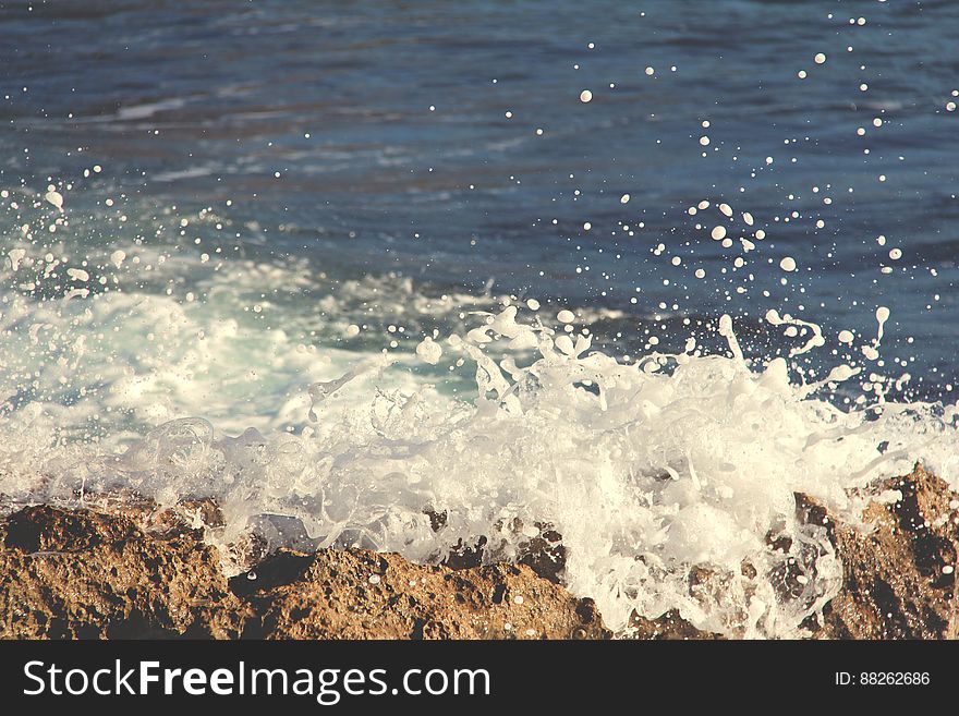 Ocean Water Splashing On Rocks