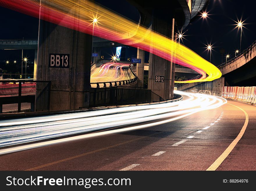 Streaks of lights from headlights on bridge at night. Streaks of lights from headlights on bridge at night.