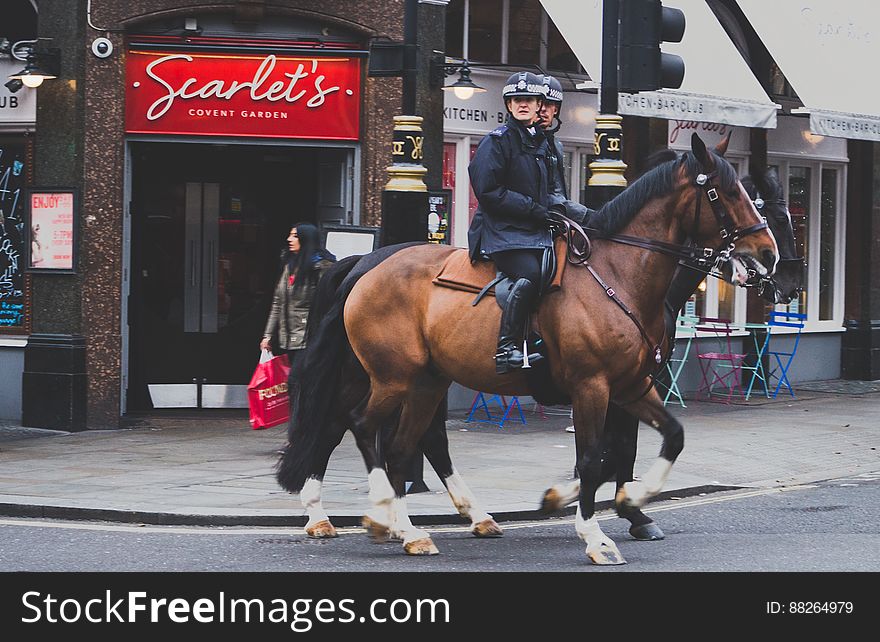 Mounted police officers on horseback outside pub in London, England. Mounted police officers on horseback outside pub in London, England.