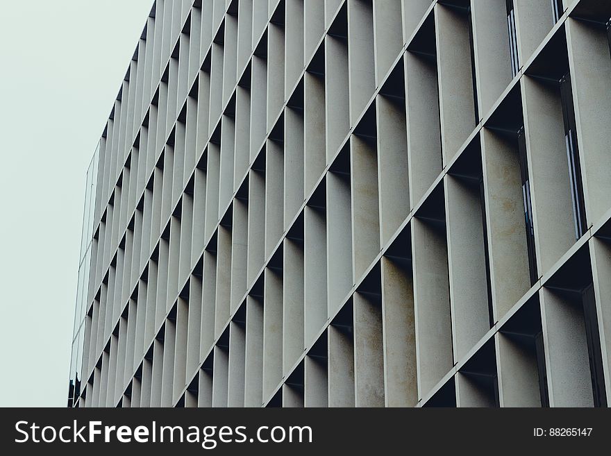 Modern high rise building with concrete frame around each window producing an abstract repetitive honeycomb structure. Modern high rise building with concrete frame around each window producing an abstract repetitive honeycomb structure.