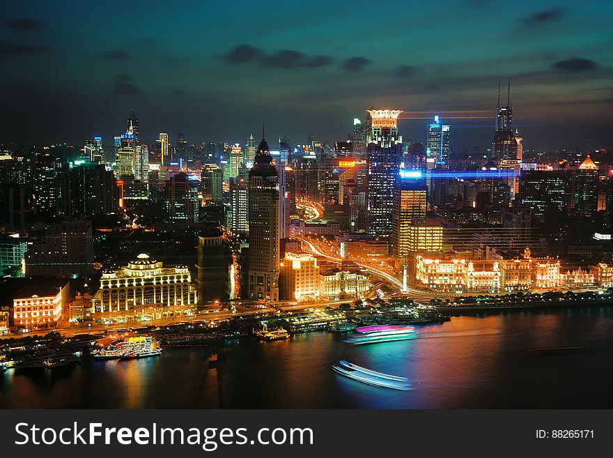 The city of Shanghai at night as seen from the Huagnpu river.
