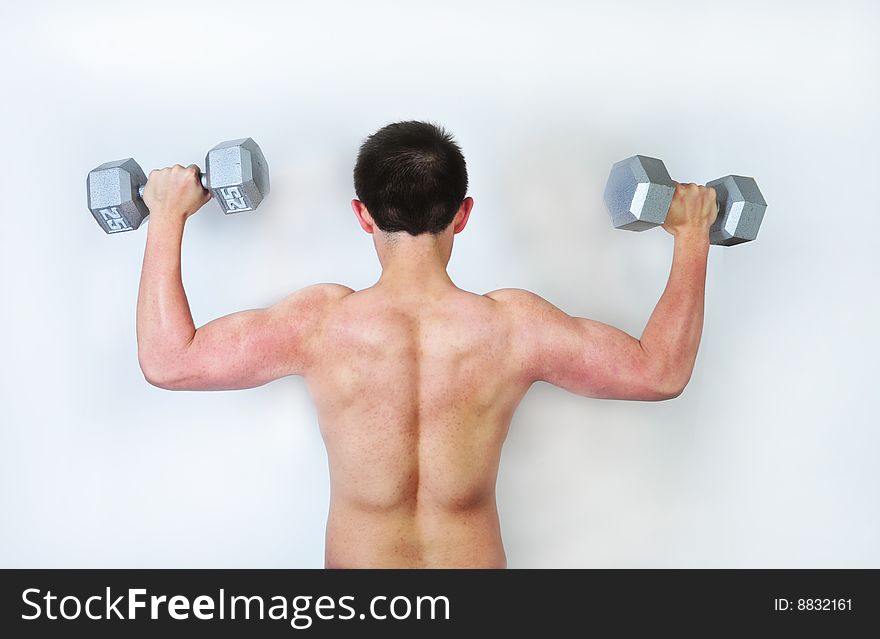 Young male lifting weights on white background.