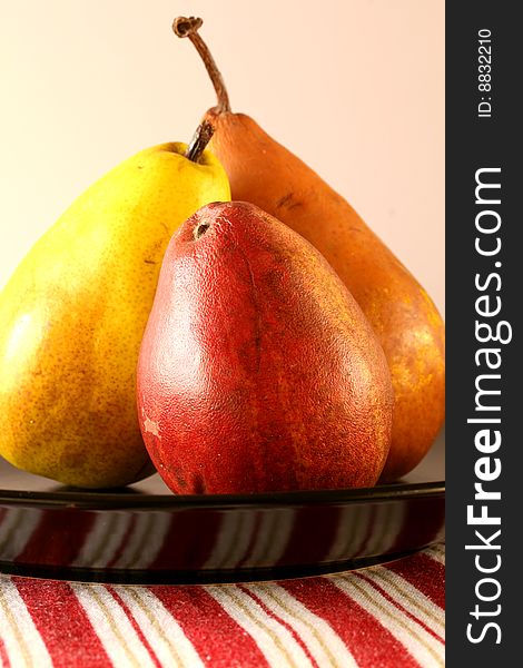 Three pears on black plate