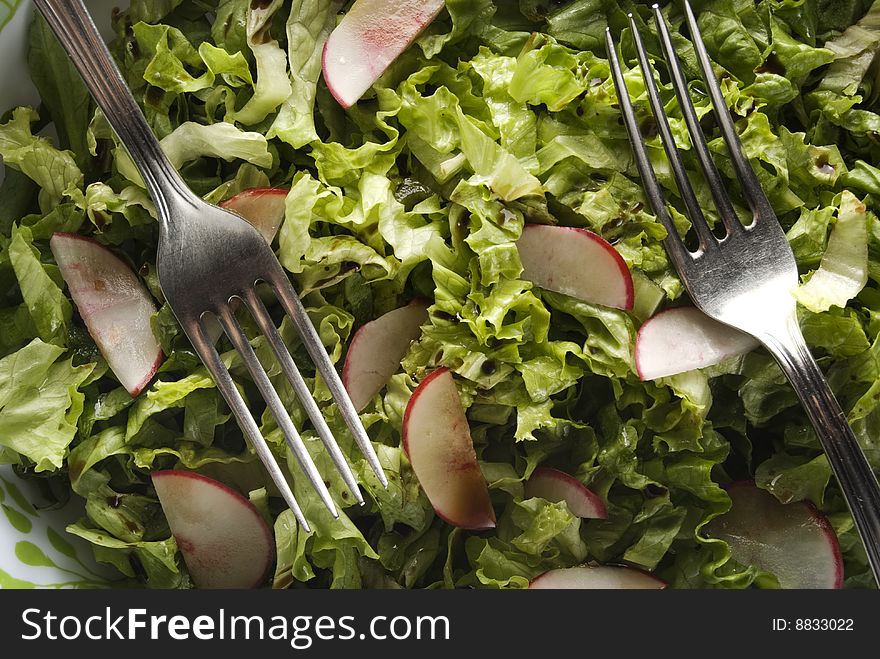 Green salad with turnip and forks