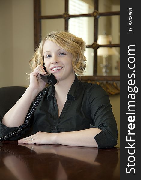 Receptionist welcoming customers at front desk, Explaining what they will need to qualify for an apartment lease. Receptionist welcoming customers at front desk, Explaining what they will need to qualify for an apartment lease