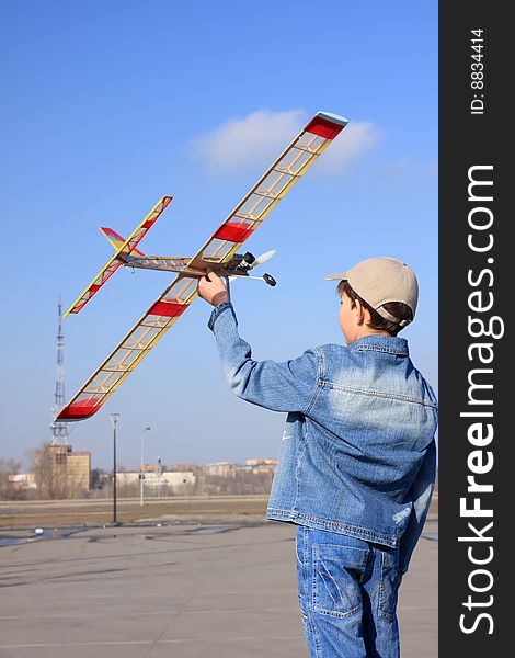 A boy starts the model of airplane in sky. A boy starts the model of airplane in sky.