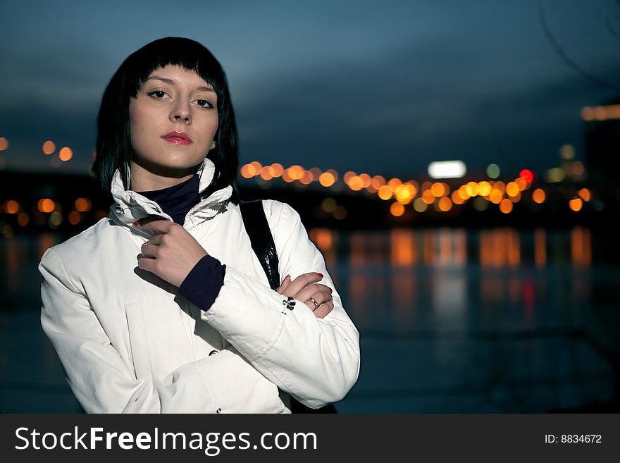 Beautiful young woman portrait in night city