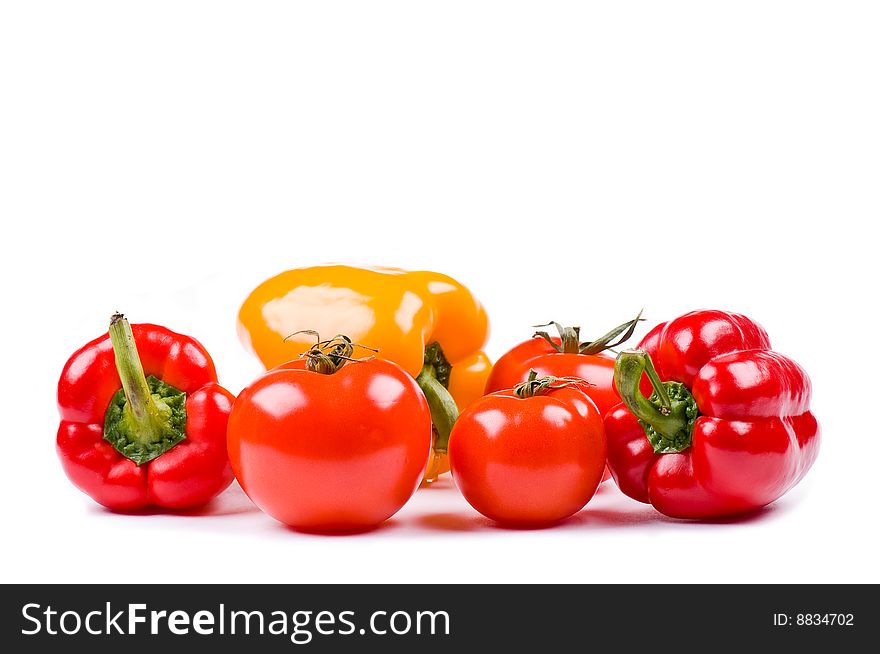 Tomatoes and sweet peppers on the white background