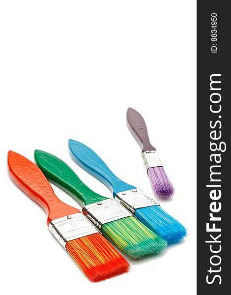 Four colorful isolated paint brushes