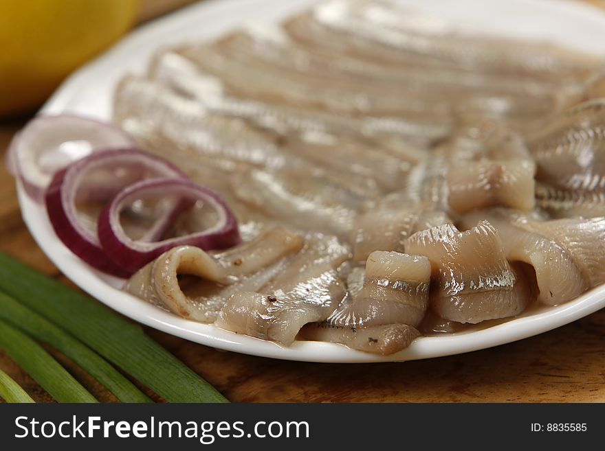 Salted anchovies on white plate