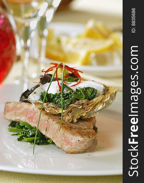 Grilled tuna fish fillet on white plate