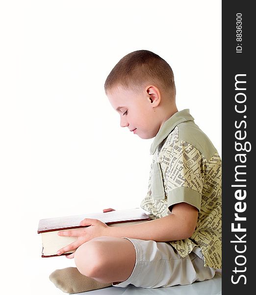 The child with book on the white