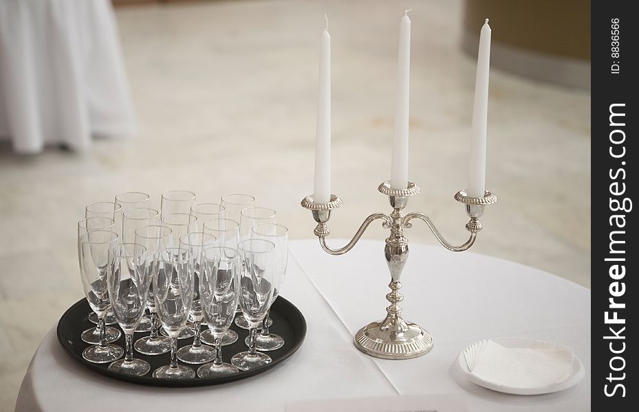 Champagne glasses and candle on a table. Champagne glasses and candle on a table