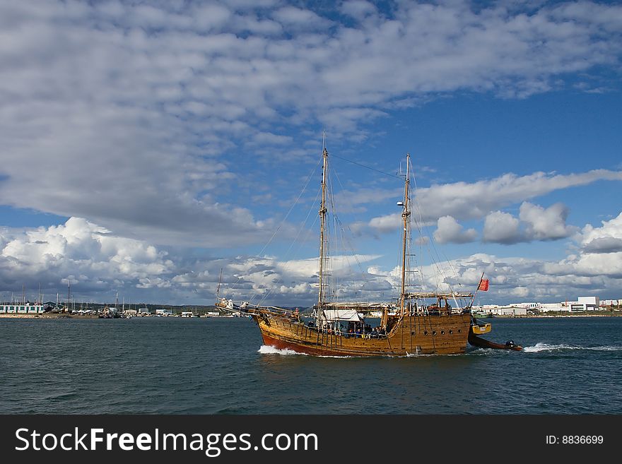 Sailing ship wit tourists with  a blue sky and a clouds on a background