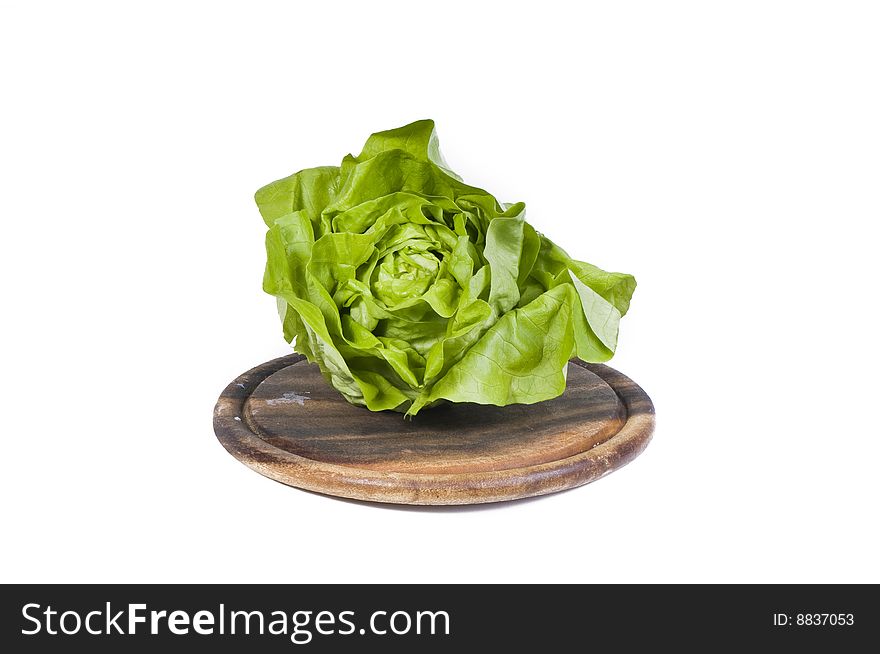 Healthy vegetables isolated on a wooden cutting board