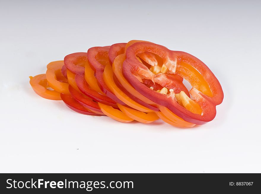 Sliced sweet red and yellow peppers isolated on white