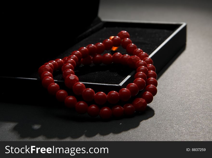 Red coral beads in a black casket