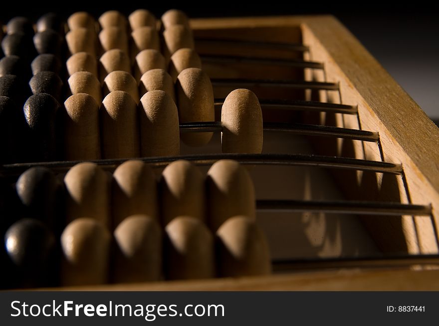 Obsolete wooden abacus, black background