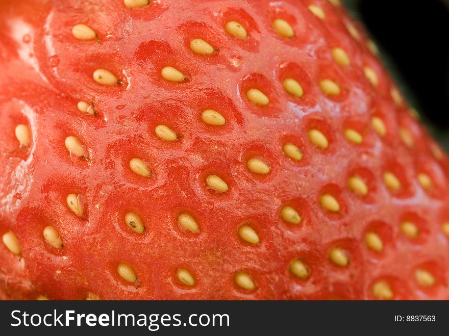 Macro image of a strawberry on a black background. Macro image of a strawberry on a black background