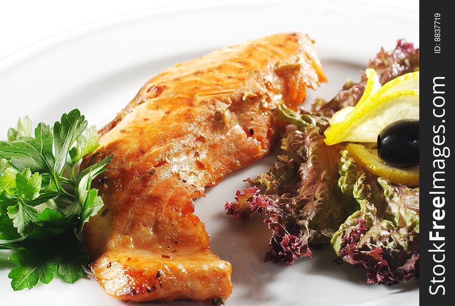 Hot Fish Dishes - Salmon Fillet with Fresh Salad Leaf and Parsley