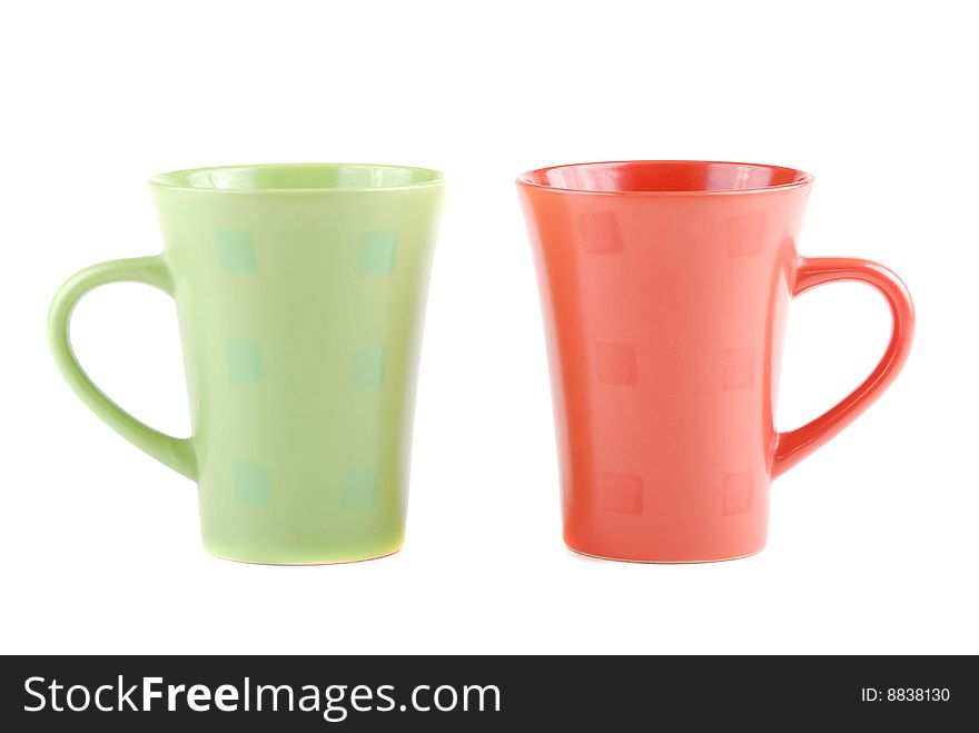 Colour cups for tea and coffee. A small white teapot. Colour cups for tea and coffee. A small white teapot.