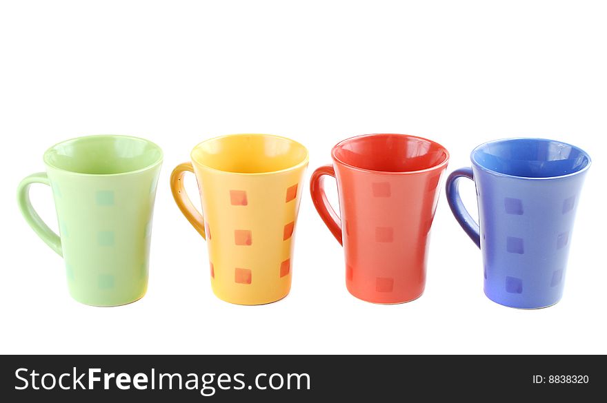 Colour cups for tea and coffee. A small white teapot. Colour cups for tea and coffee. A small white teapot.