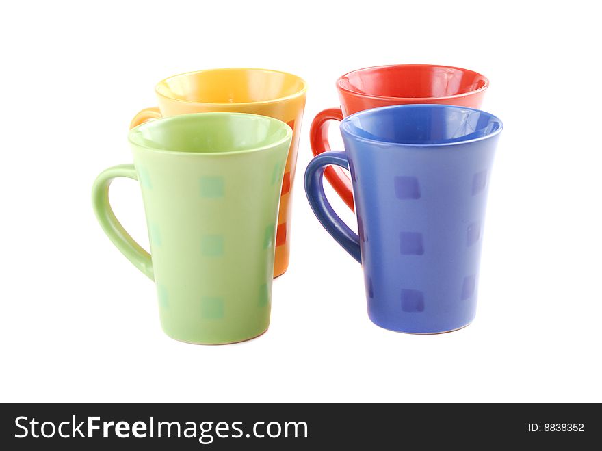 Colour cups for tea and coffee. A small white teapot. Colour cups for tea and coffee. A small white teapot.