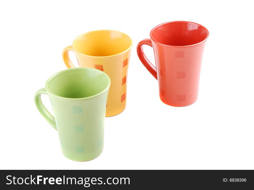 Colour cups for tea and coffee. A small white teapot. Colour cups for tea and coffee. A small white teapot.
