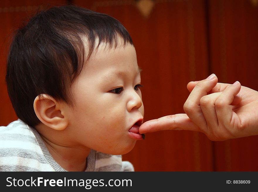 Mom feed a child with finger. Mom feed a child with finger