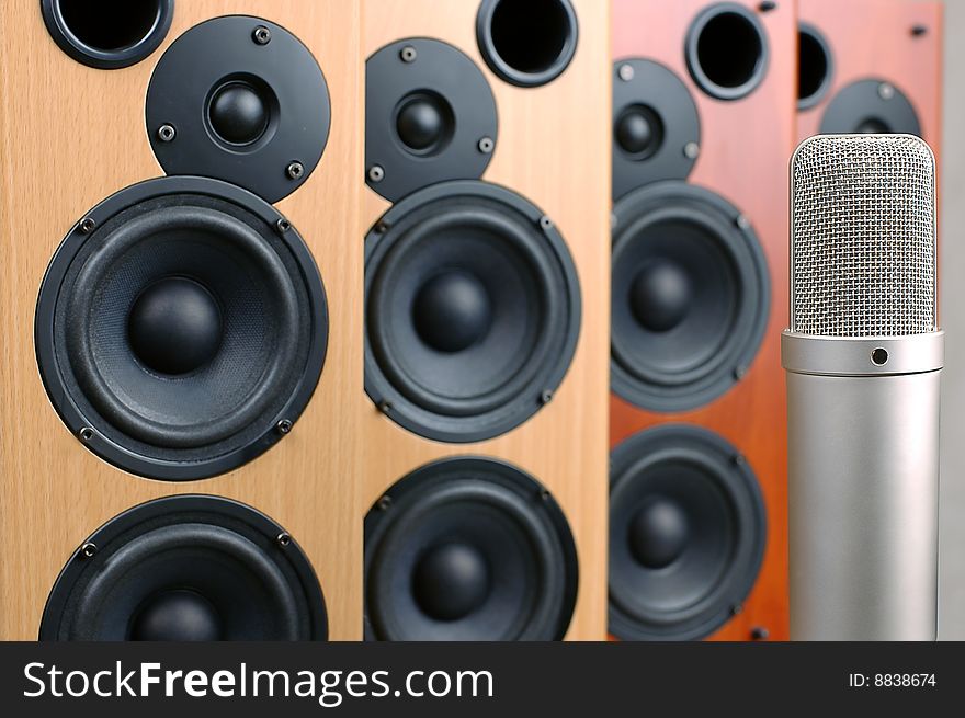 Microphone in sound studio on a background of acoustic systems