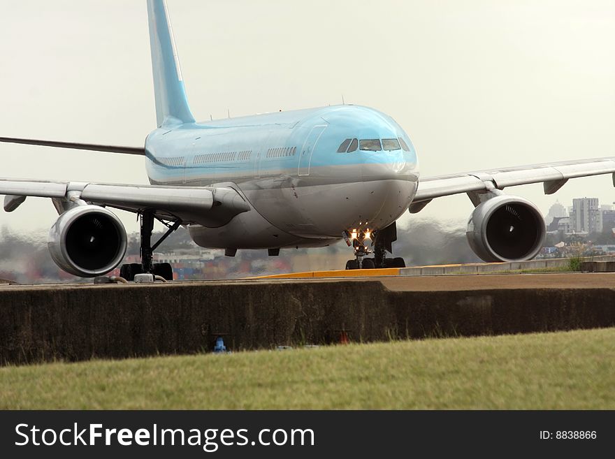 Blue and silver passenger jet on the runway. Blue and silver passenger jet on the runway.