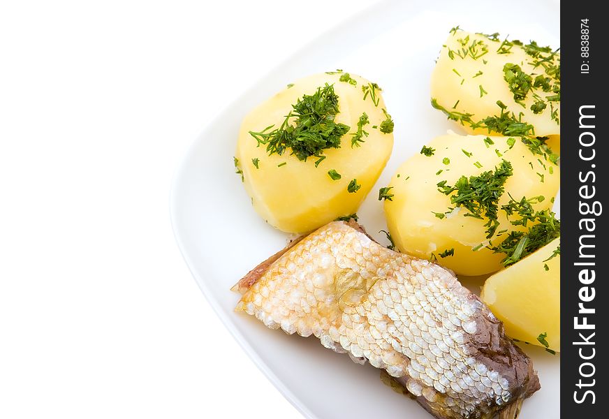 Close-up plate of potato with fish isolated on white background