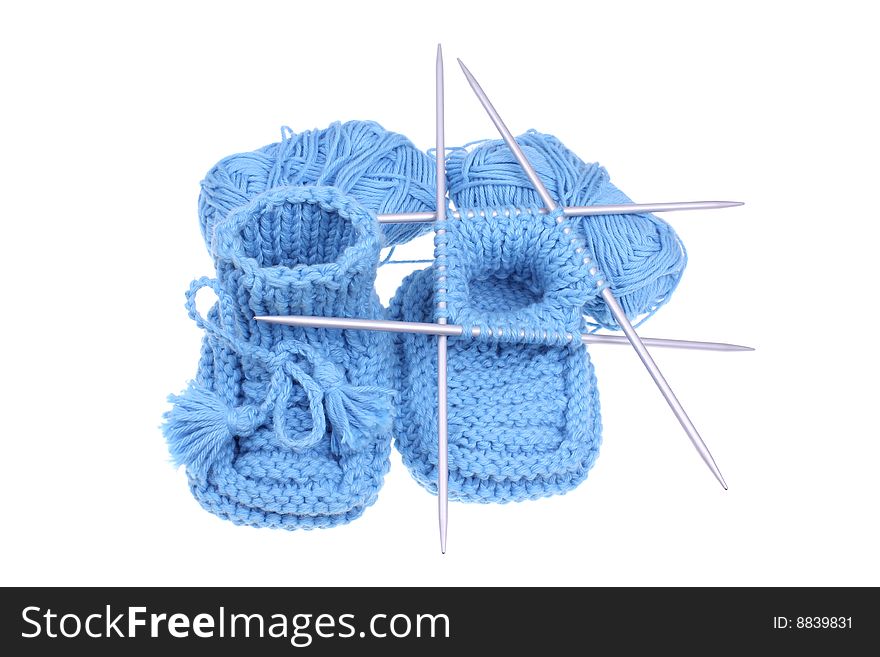 Close up look on woollen baby shoes isolated in white.