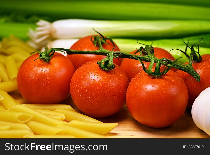 Close Up Photo of Red Tomatoes Near Pasta