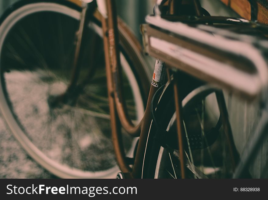 Close up of bike frame and tire on streets.