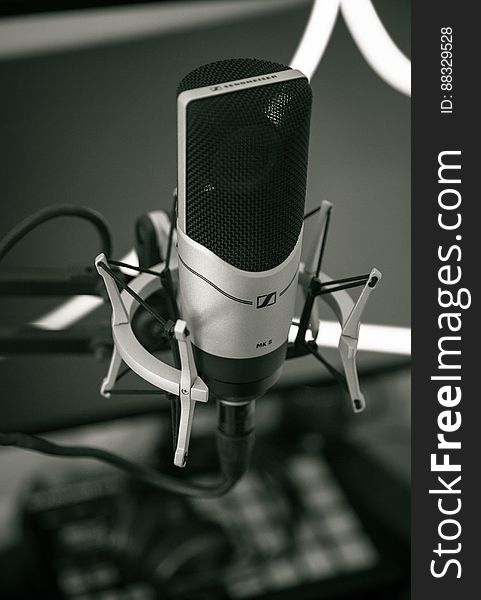 Close up of recording microphone on metal stand in black and white. Close up of recording microphone on metal stand in black and white.