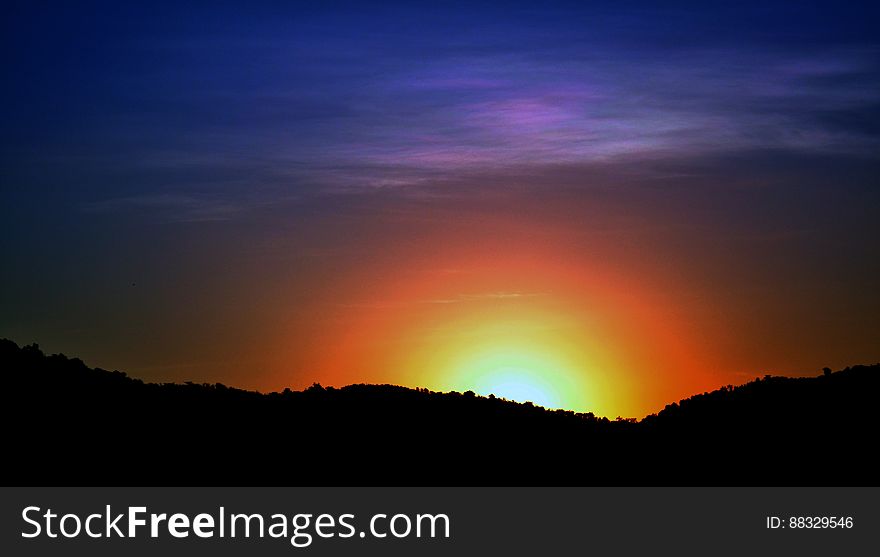 Silhouette of hillside at sunset with colorful skies. Silhouette of hillside at sunset with colorful skies.