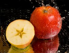 Full Apple And Half With Water Splashing Royalty Free Stock Images