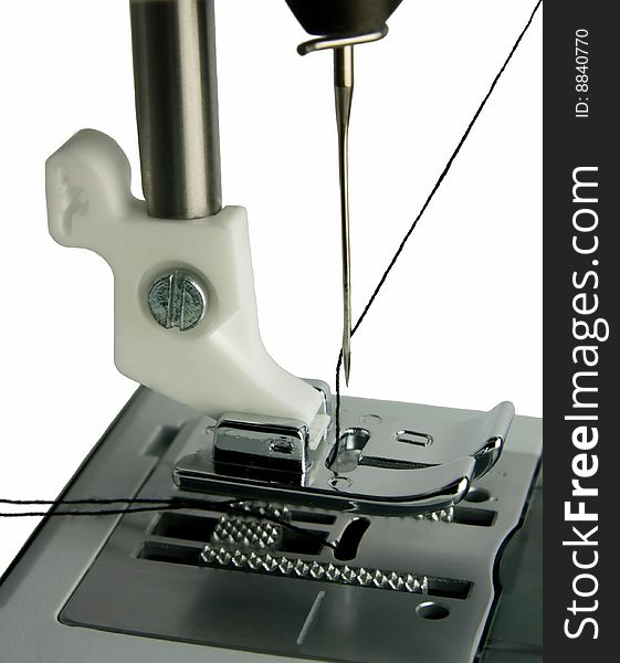 Isolated sewing machine foot closeup and needle