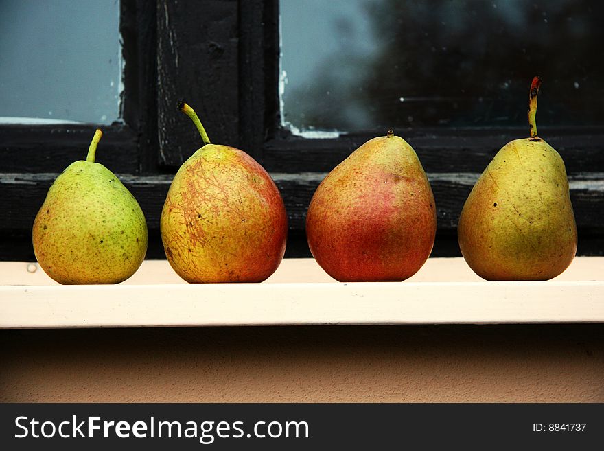 Four pears lying on the window sills