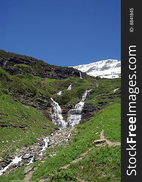 Glacier National Park Waterfall, early summer. Glacier National Park Waterfall, early summer