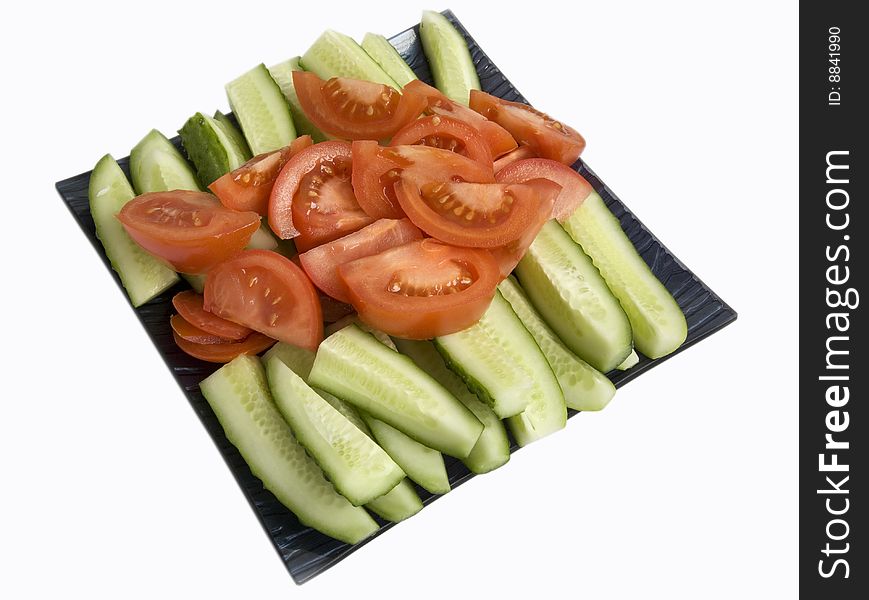 Cut red tomatoes and green cucumbers. Cut red tomatoes and green cucumbers