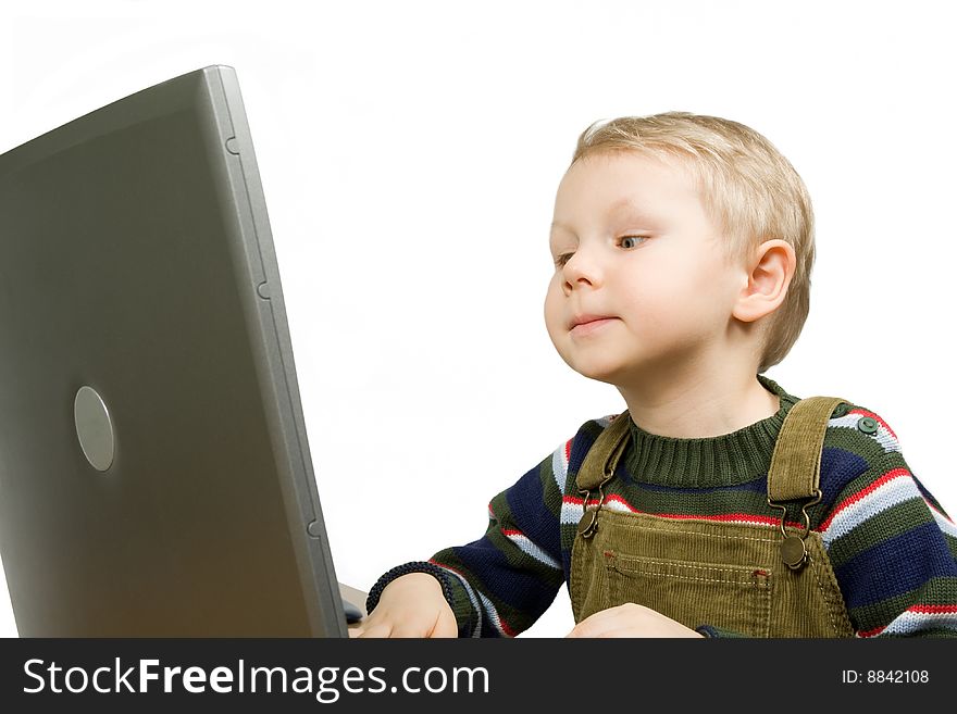 Small boy gets knowledge with laptop isolated on white. Small boy gets knowledge with laptop isolated on white