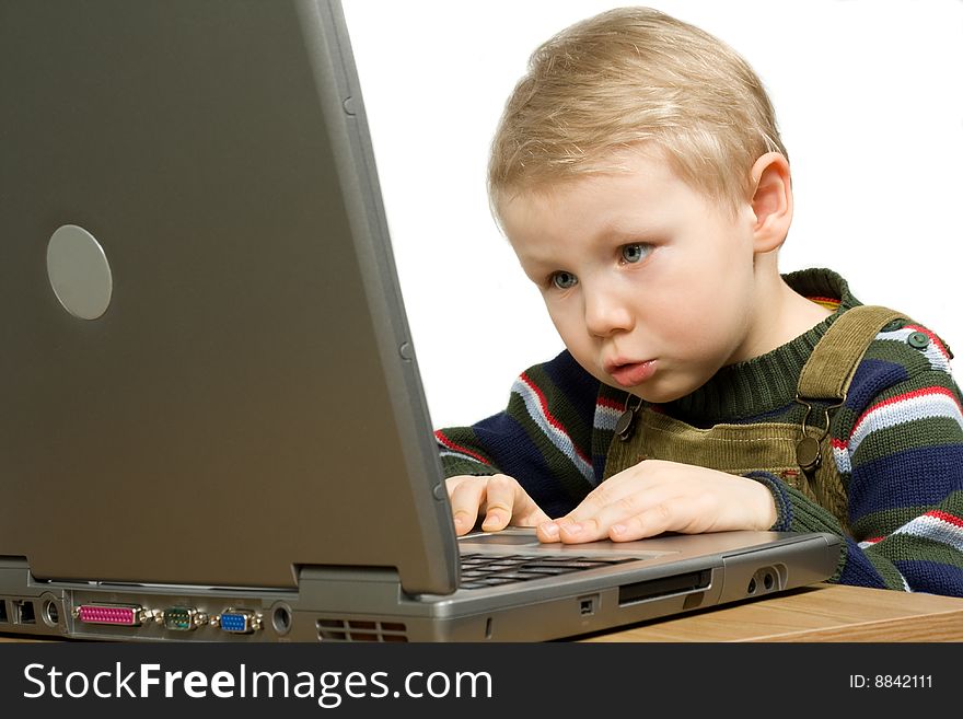 Small boy gets knowledge with laptop isolated on white. Small boy gets knowledge with laptop isolated on white