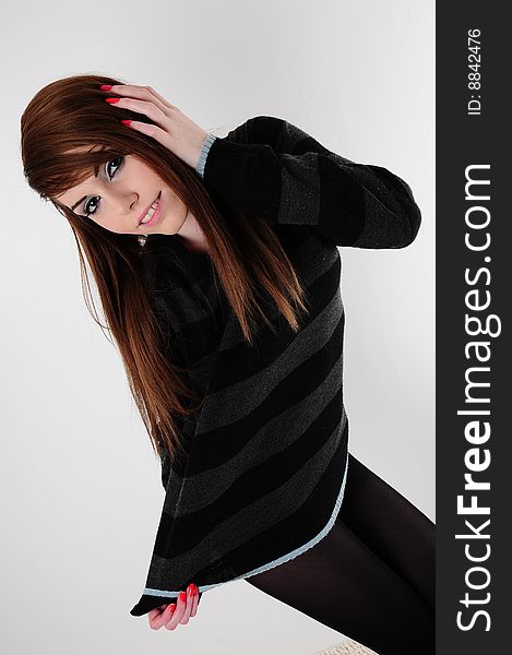 Female fashion model wearing a black stripped jumper and a pair of black leggings. Female fashion model wearing a black stripped jumper and a pair of black leggings