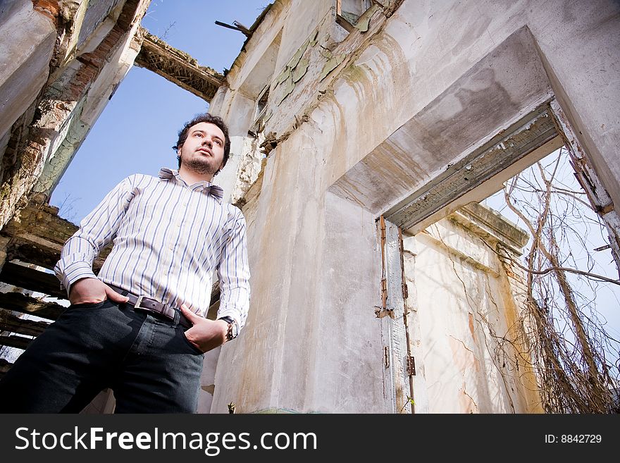 Young man in abandoned building, low angle of view
