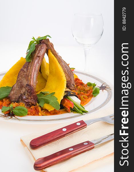 Roasted meat and vegetables over light background