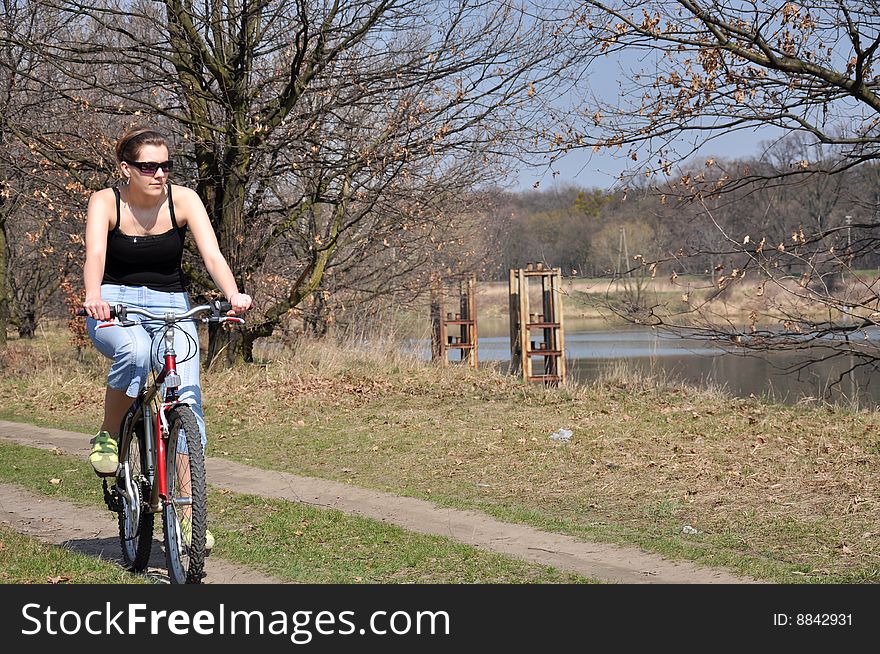 Girl riding a bike in spring scenery. Girl riding a bike in spring scenery